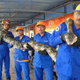 Members of Malaysia’s civil defence force pose with the python. Image: Herme Herisyam, Malaysia’s Civil Defence Force
